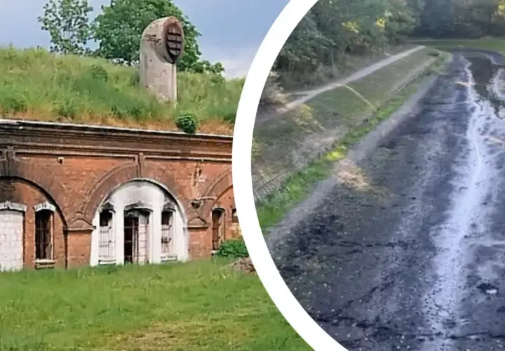 Fort Bema, z ceglanymi łukami i porośniętym trawą dachem, obok wyschniętego koryta.